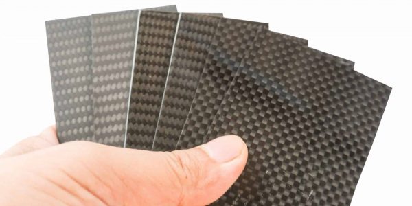 carbon fiber specimen sample plate in hand holder on white isolate with path linebackground